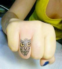 Finger owl tattoo